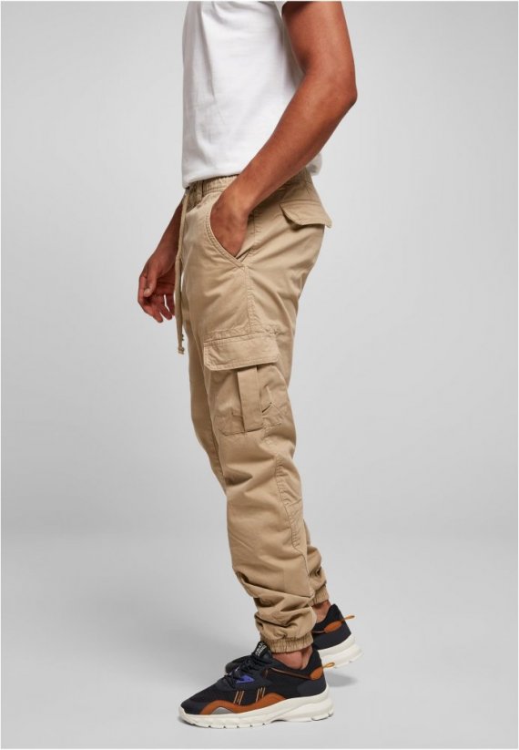 Męskie spodnie Urban Classics Cargo Jogging Pocket — beżowe